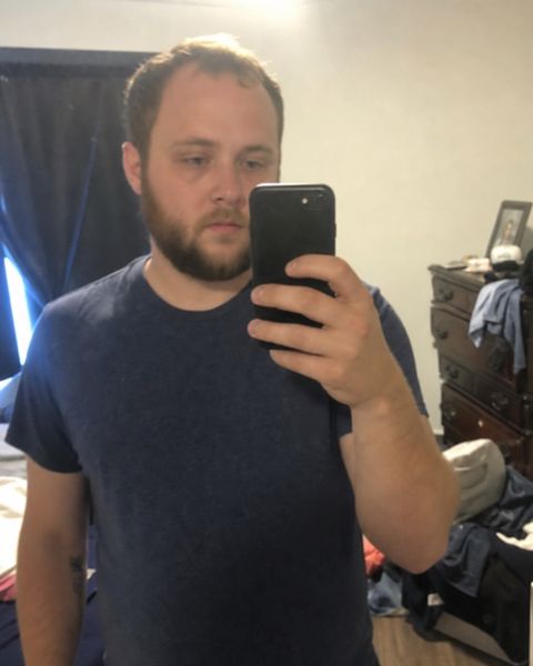 Mirror selfie in a messy room